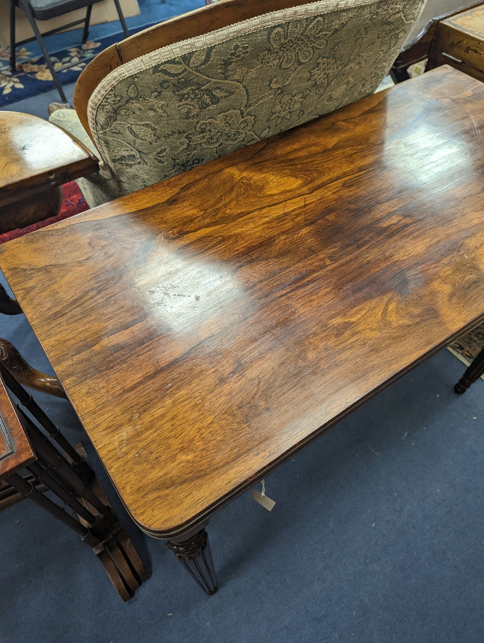 A Regency rosewood brass mounted rectangular folding card table with fluted legs, in the manner of Gillows, width 95cm, depth 47cm, height 75cm